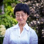 Portrait of Theresa Lee with green and brown background